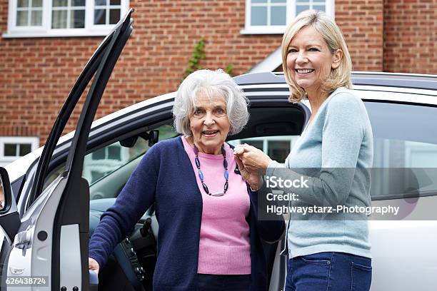Female Neighbor Giving Senior Woman A Lift In Car Stock Photo - Download Image Now - Senior Adult, Driving, Assistance