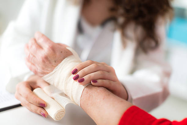 Young nurse treating senior patient