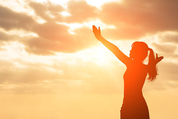 istock silhouette of woman pray 626442142