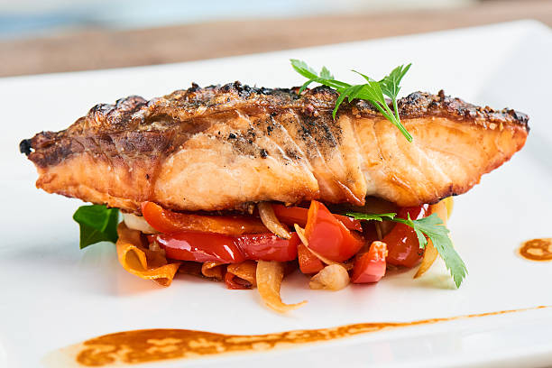 istock Back of salmon grilled and vegetables served on white plate 626442816