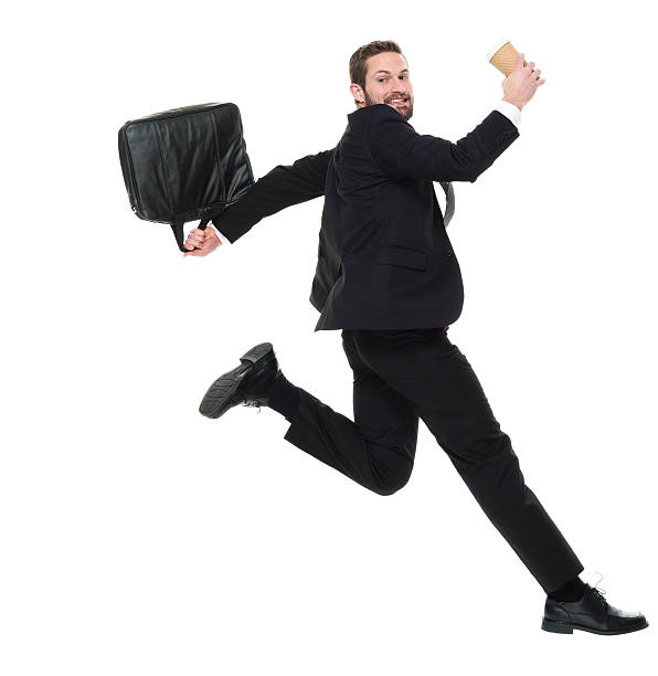 istock Smiling businessman jumping 626442840