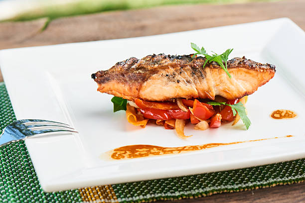 istock Back of salmon grilled and vegetables served on white plate 626442868
