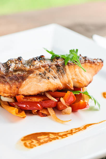 istock Back of salmon grilled and vegetables served on white plate 626442976