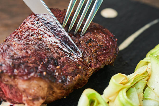 istock Cutlery cut marbled beef on a stone Board 626443530