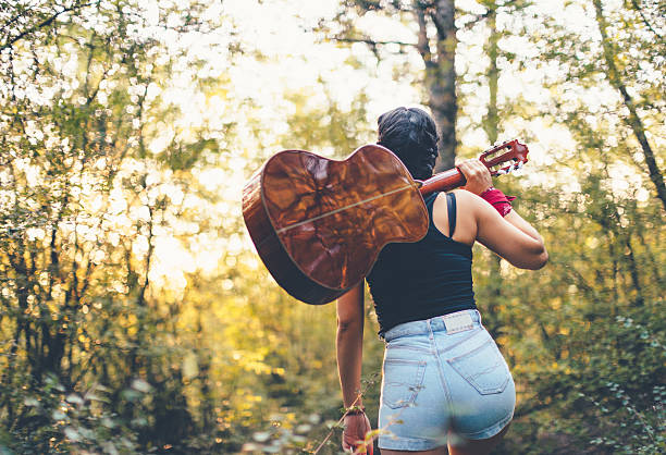 Beautiful young woman walking away with my guitar