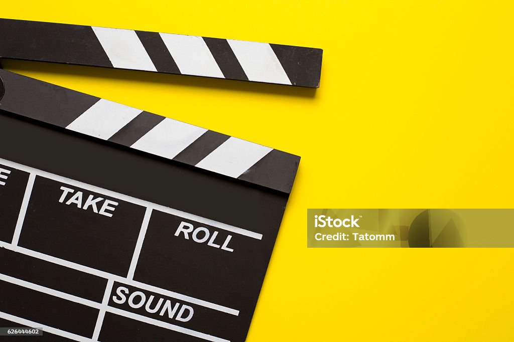 movie clapper on yellow background Movie Stock Photo
