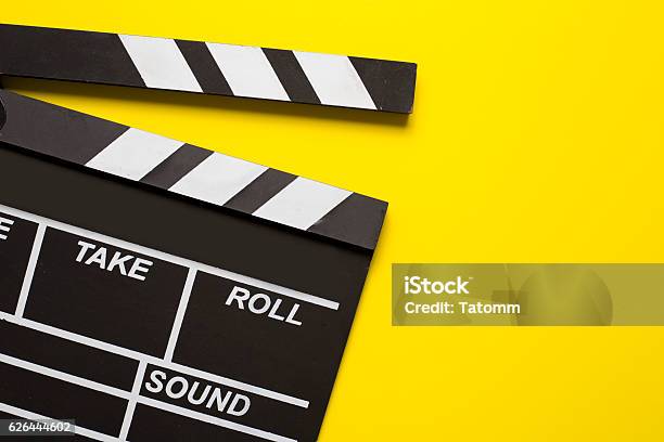 Movie Clapper On Yellow Background Stock Photo - Download Image Now - Movie, Yellow, Film Industry