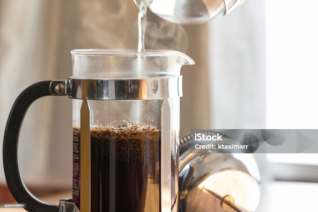 Coffee Brewing Coffee brewing in a French press in warm morning light; French Press Stock Photo