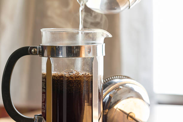 Coffee Brewing Coffee brewing in a French press in warm morning light; decaffeinated photos stock pictures, royalty-free photos & images
