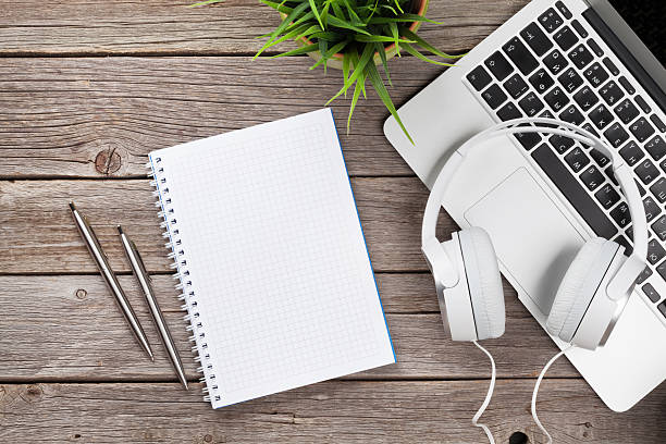 istock Headphones over laptop and notepad 626445784