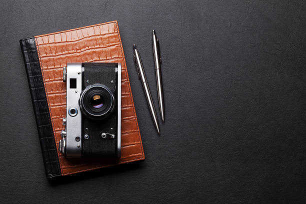 istock Office desk with camera, notepad, pen and pencil 626446230