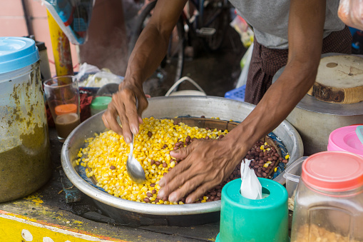 Street food in Yangon, Myanmar - Beans, corn, pepper chutney, lime, salt, and other greens