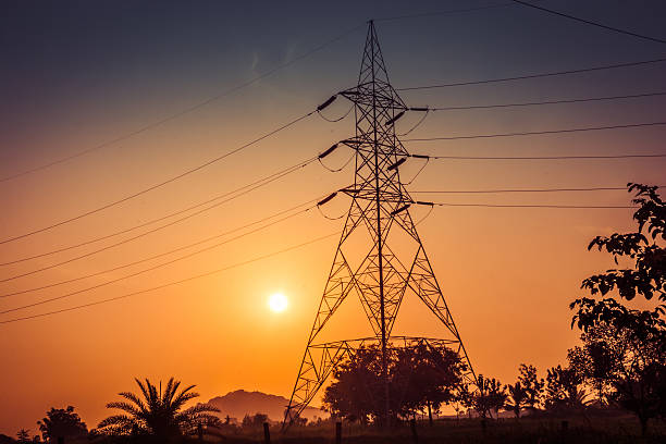 istock Electricity pylons, power lines at sunset 626447002