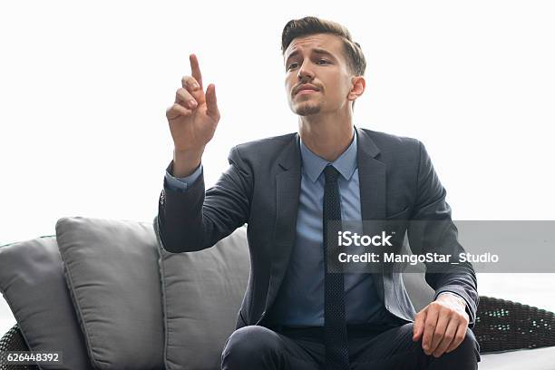 Successful Man Trying To Get Waiters Attention Stock Photo - Download Image Now - Men, Picking Up, Suit