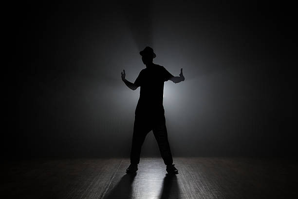 istock Man dancer posing in the dark and smoke 626448518