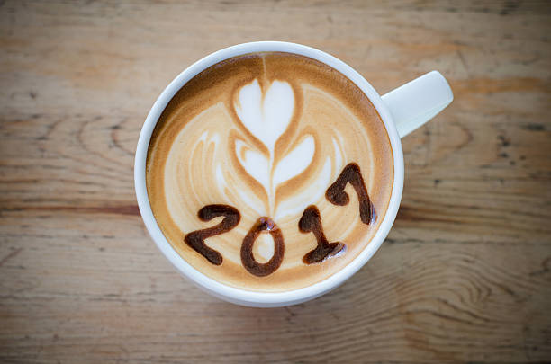 istock hot coffee with foam milk art 2017 on wooden table 626455322