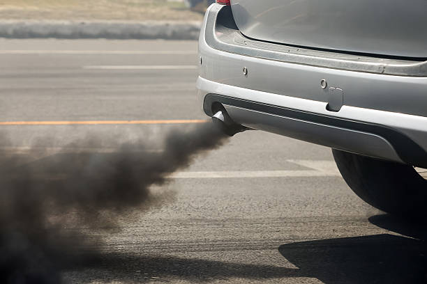 Air pollution from vehicle exhaust pipe on road Air pollution from vehicle exhaust pipe on road smog car stock pictures, royalty-free photos & images