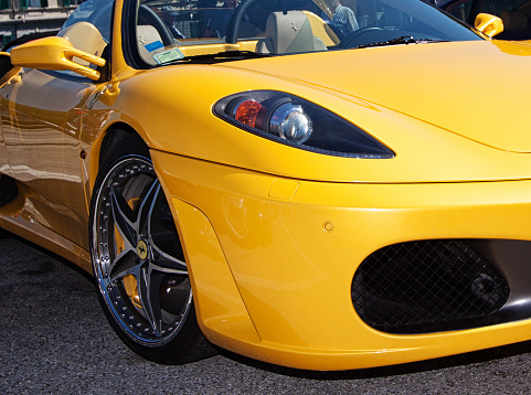Gorizia, Italy - June 8, 2014: Yellow Ferrari F430, front side view, parked and exhibited at the old timer car meeting Antiche Scuderie Isontine in the town of Gorizia in Italy. Some curious people in background