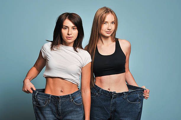 istock Women shows her weight loss. 626457762