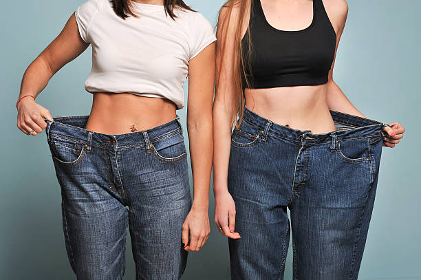 istock Women shows her weight loss. 626457834
