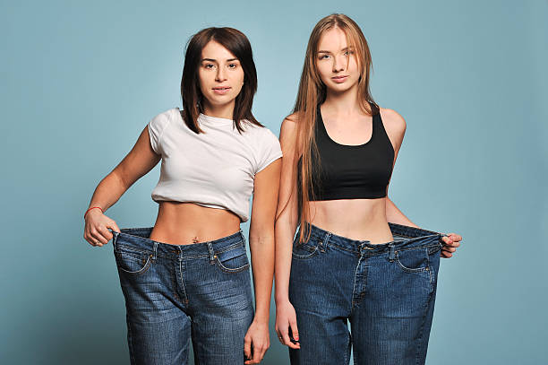 istock Women shows her weight loss. 626457908