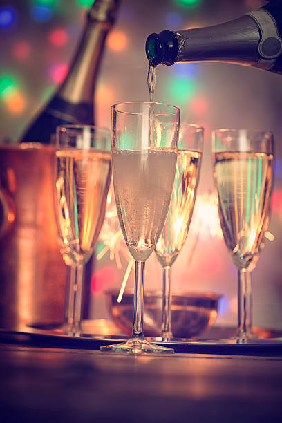 istock Pouring Champagne into Champagne Flutes 626458228
