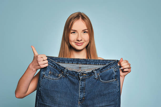 istock Fit young woman in loose jeans 626461094