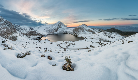 Covadonga lakes beautiful snowy winter landscape scene on a touristic location of Asturias, Spain, Europe, surrounded by mountains. Snow adventure leisure destination for holidays or vacations.