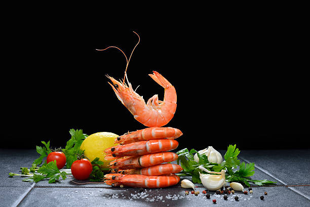 Cooked shrimps,prawns Cooked shrimps,prawns with seasonings on stone background food state preparation shrimp prepared shrimp stock pictures, royalty-free photos & images