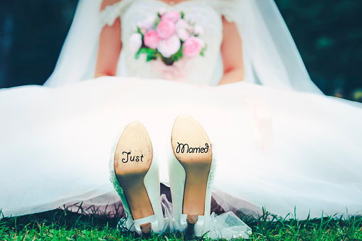 Bride with 'Just Married' written on shoes