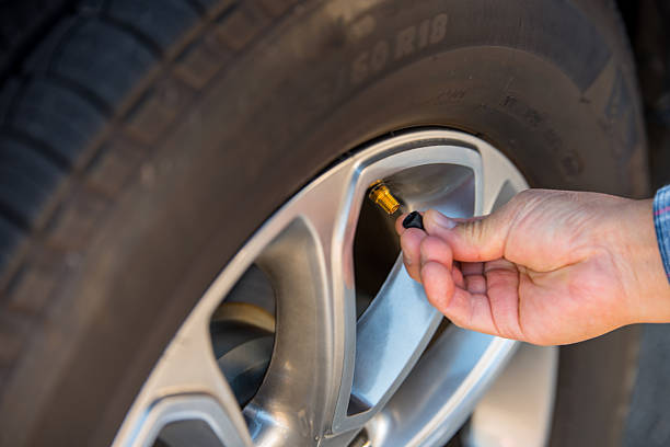 Checking Tire Valve Stem Stock Photo - Download Image Now - Air