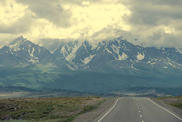 istock Long asphalt road. Mountains in the horizon. Evening. Beautiful toning 626463482