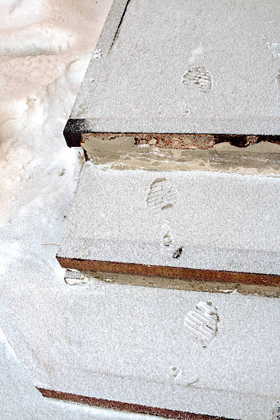 istock Human footprints on the snowy stairs. 626463530