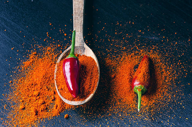 istock Red chilly peppers on a wooden spoon  with spicy. 626464344