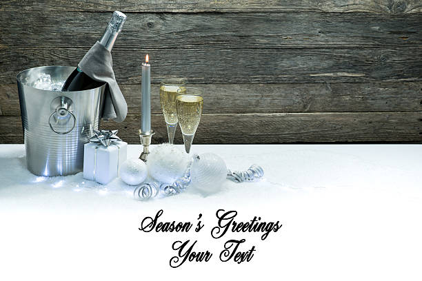 holiday background card with blank space for season's greetings message text with champagne and christmas or new year decoration