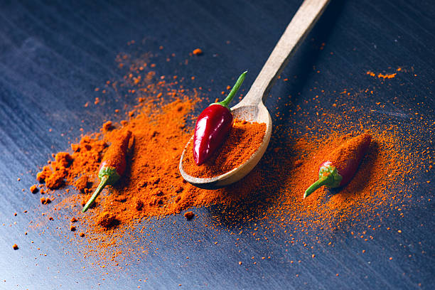 istock Red chilly peppers on a wooden spoon  with spicy. 626464642