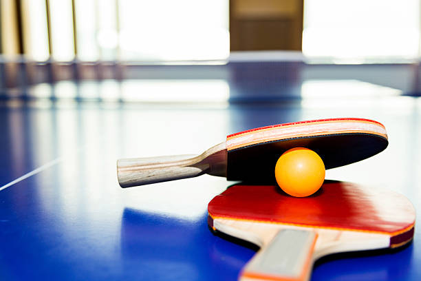 istock Ping-Pong paddles with ball on table 626465250