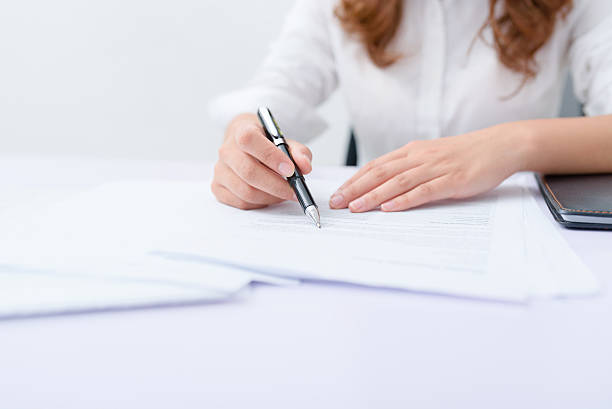 istock Business woman filling information on document. 626465414