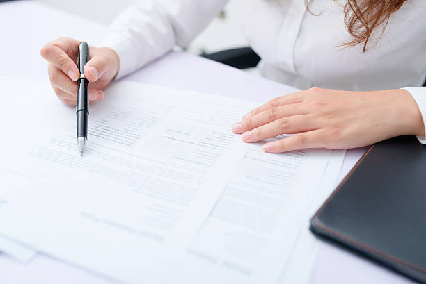 istock Business woman filling information on document. 626465478