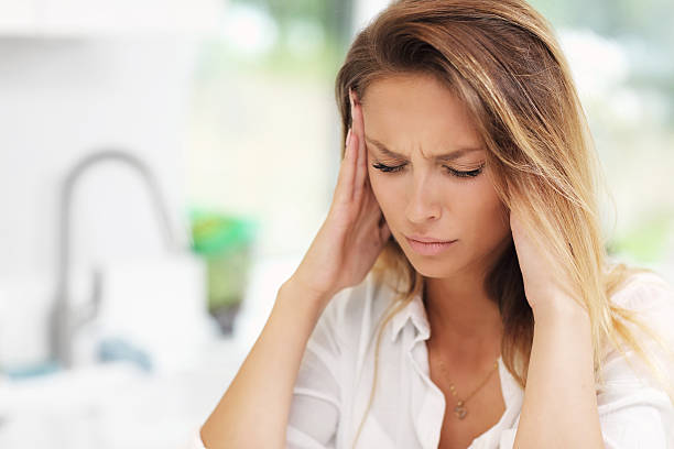 istock Young sad woman suffering from headache in kitchen 626465668