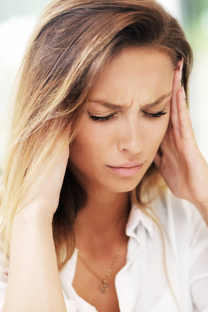 istock Young sad woman suffering from headache in kitchen 626465820