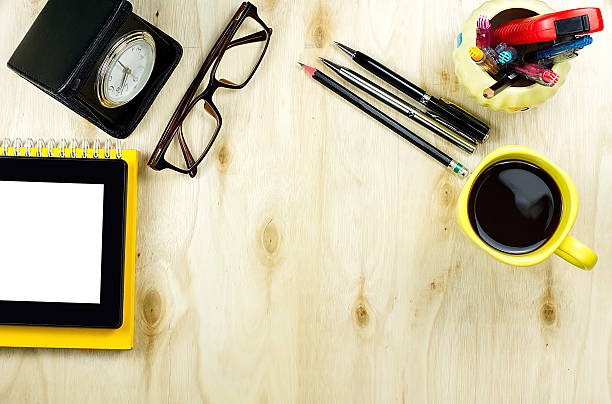 Tablet PC cup of coffee and office supply on table
