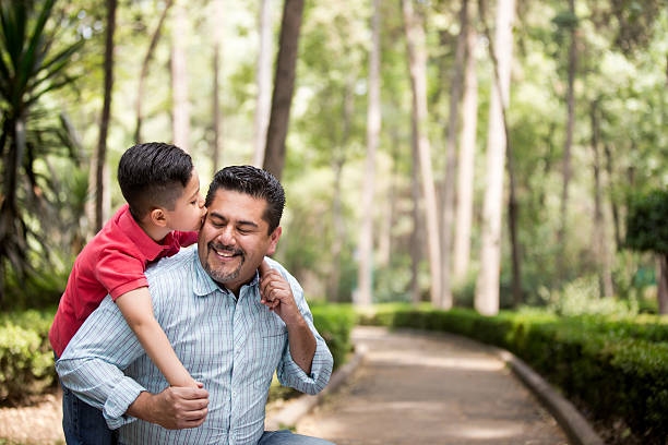 istock Little latin boy kissing his father's cheek 626467448