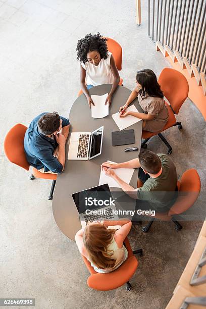Overhead View Of Five Business People At Table In Meeting Stock Photo - Download Image Now