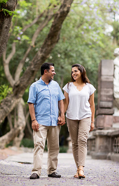 istock Romantic latin couple walking outdoors hand by hand 626490134