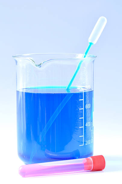 istock Chemical beaker with blue chemicals dissolved in water 626490412