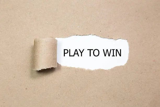 PLAY TO WIN message written under torn paper.