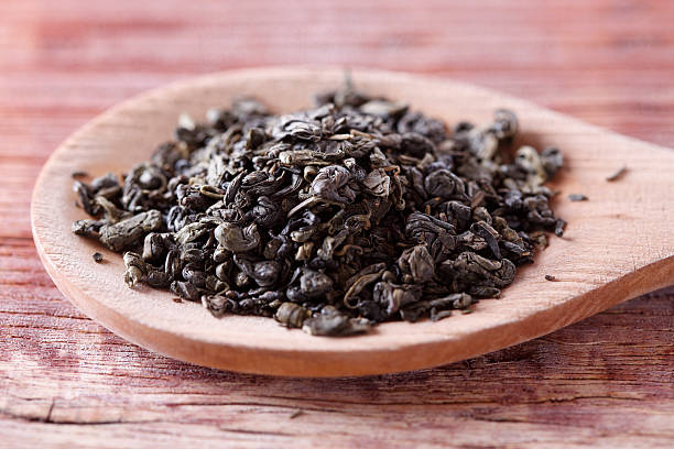 istock Green tea in wooden spoon 626492476