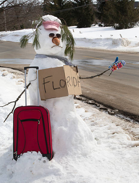 Snowman leaving town stock photo