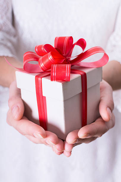 istock Woman holding a christmas gift 626501680